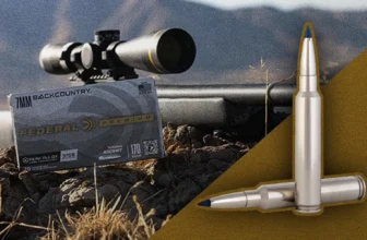 picture of federal premium 7mm backcountry ammo with suppressed sniper rifle on rock ledge in outdoor sunny setting