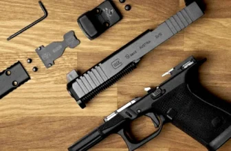 Glock 19 Gen 6 pistol field-stripped on a wood surface, with slide, frame, MOS adapter plate, red dot optic, mounting screws, and hex wrench laid out. Slide is stamped "Glock 19 Gen 6 / 9x19 / Austria.